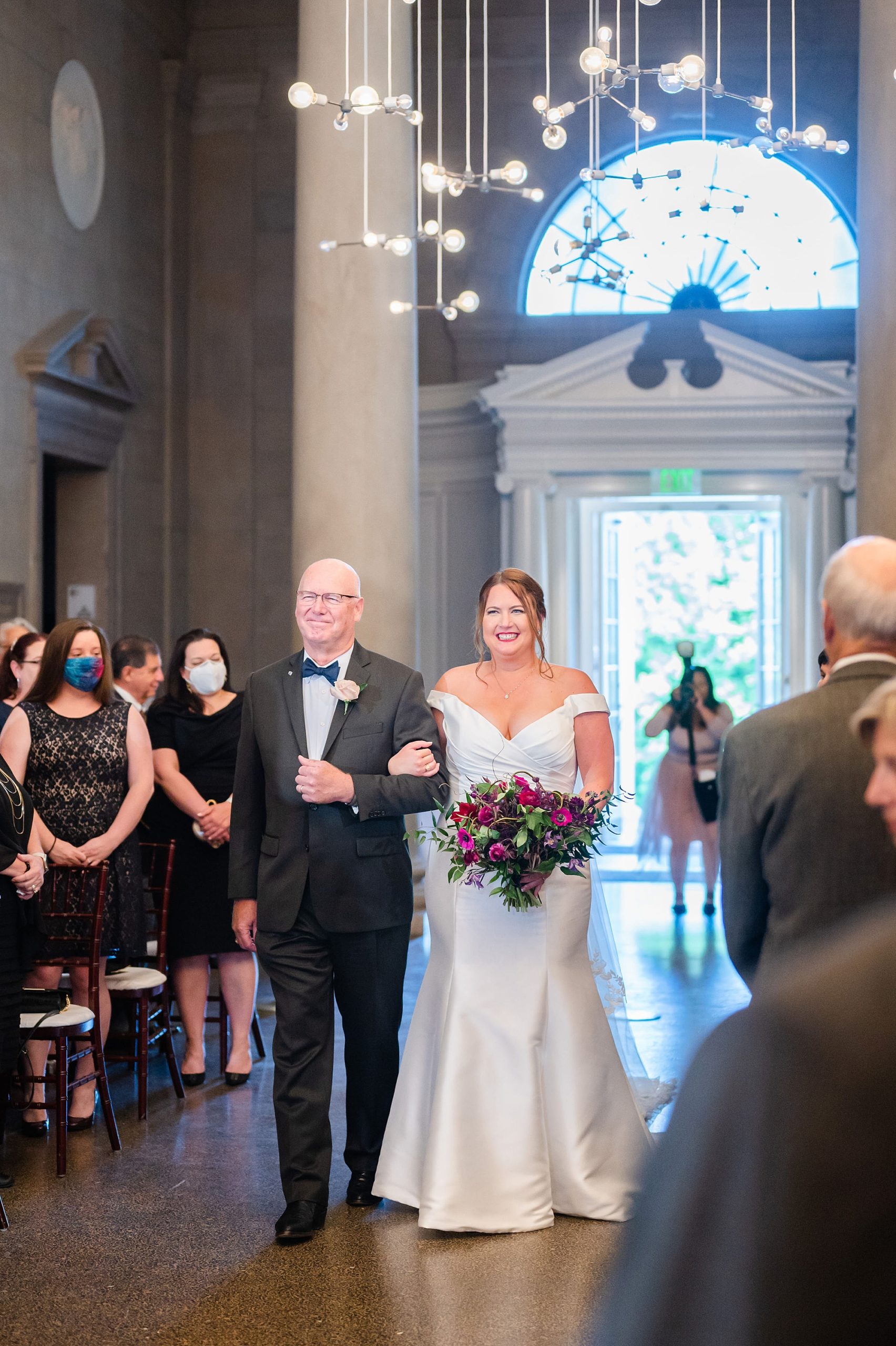 bride walks down aisle with father for traditional Jewish wedding ceremony in Baltimore 