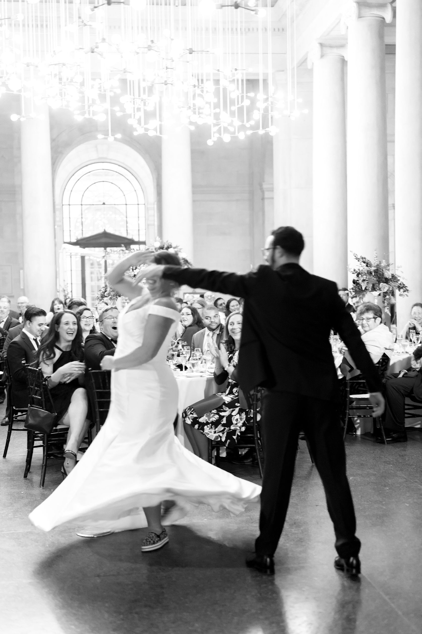 groom twirls bride during first dance at wedding reception in Baltimore MD