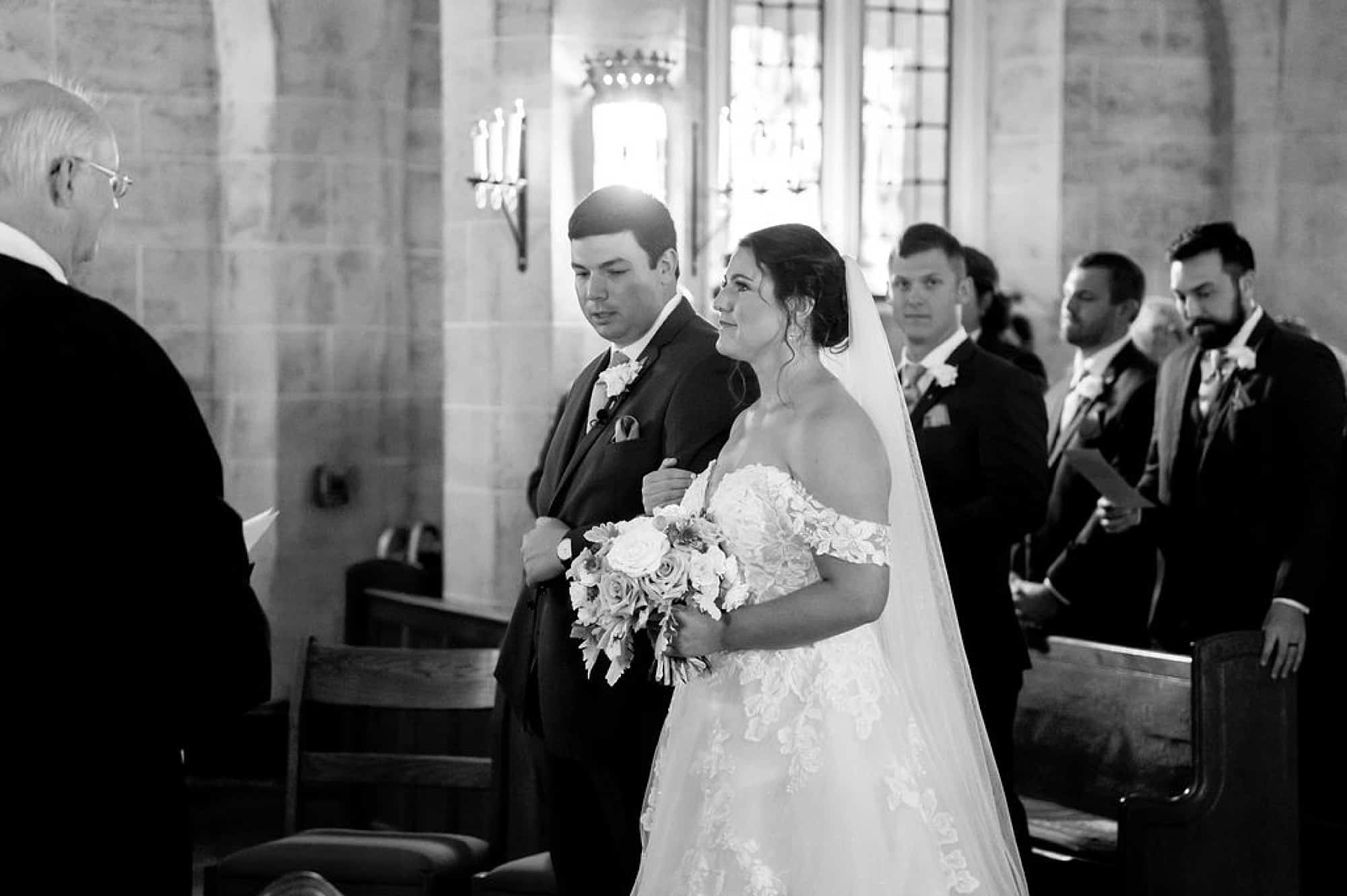 bride stands with groom during traditional church wedding at Saint Andrews in Delaware
