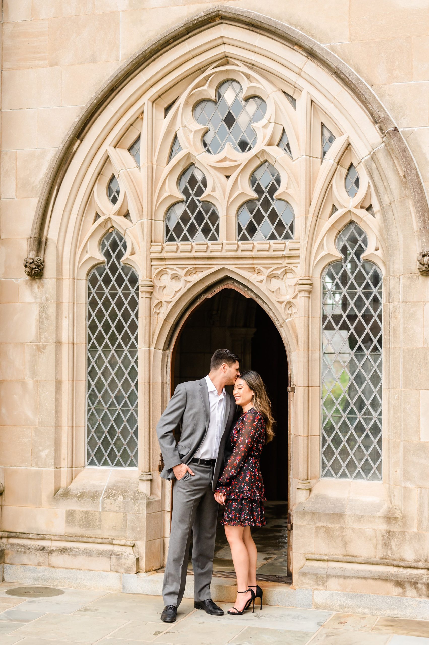groom whispers in bride's ear during portraits at DC National Cathedral