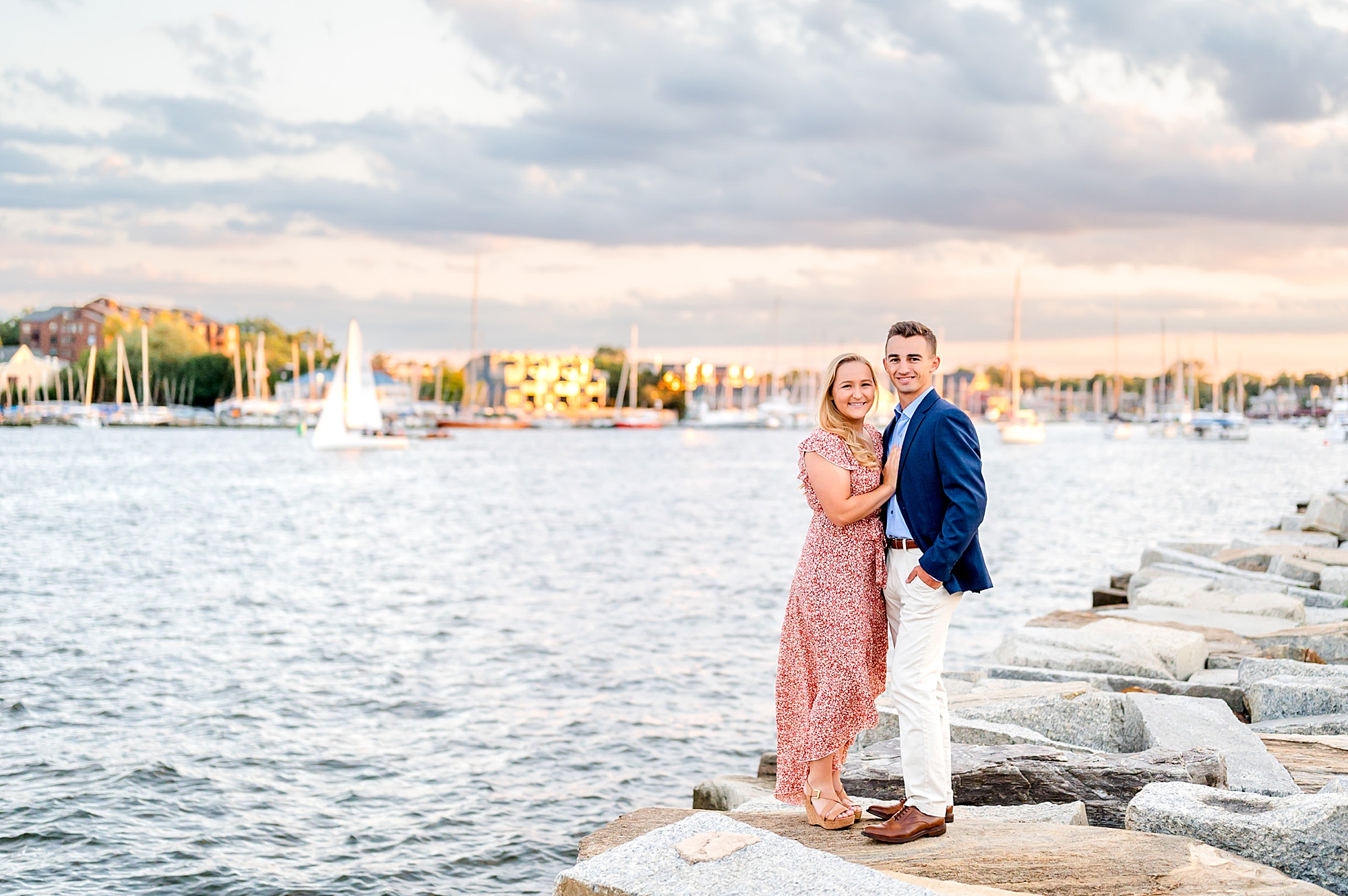 DC couple poses along waterfront in nice outfits during engagement photos