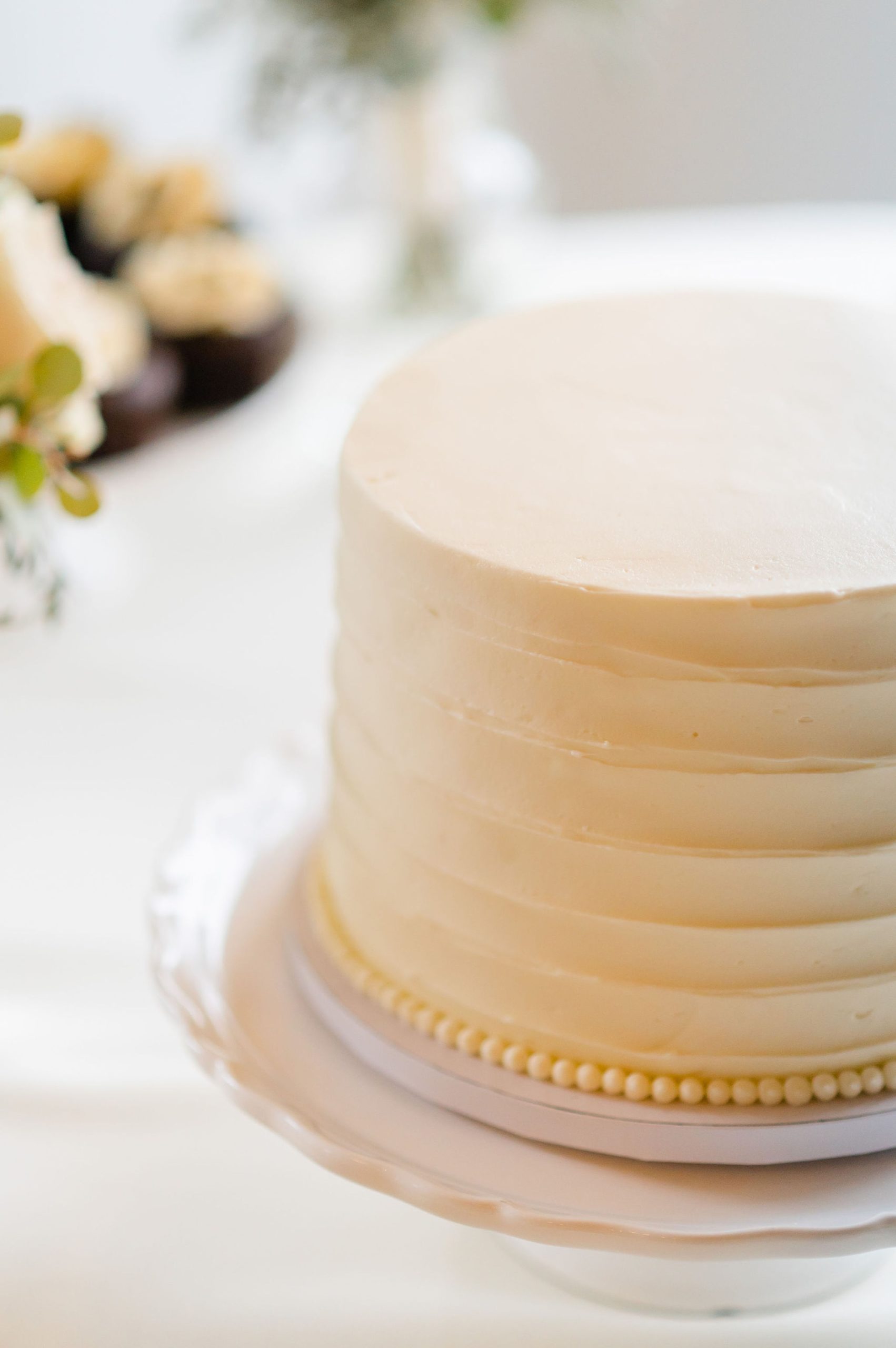 simple wedding cake with pearl details along bottom