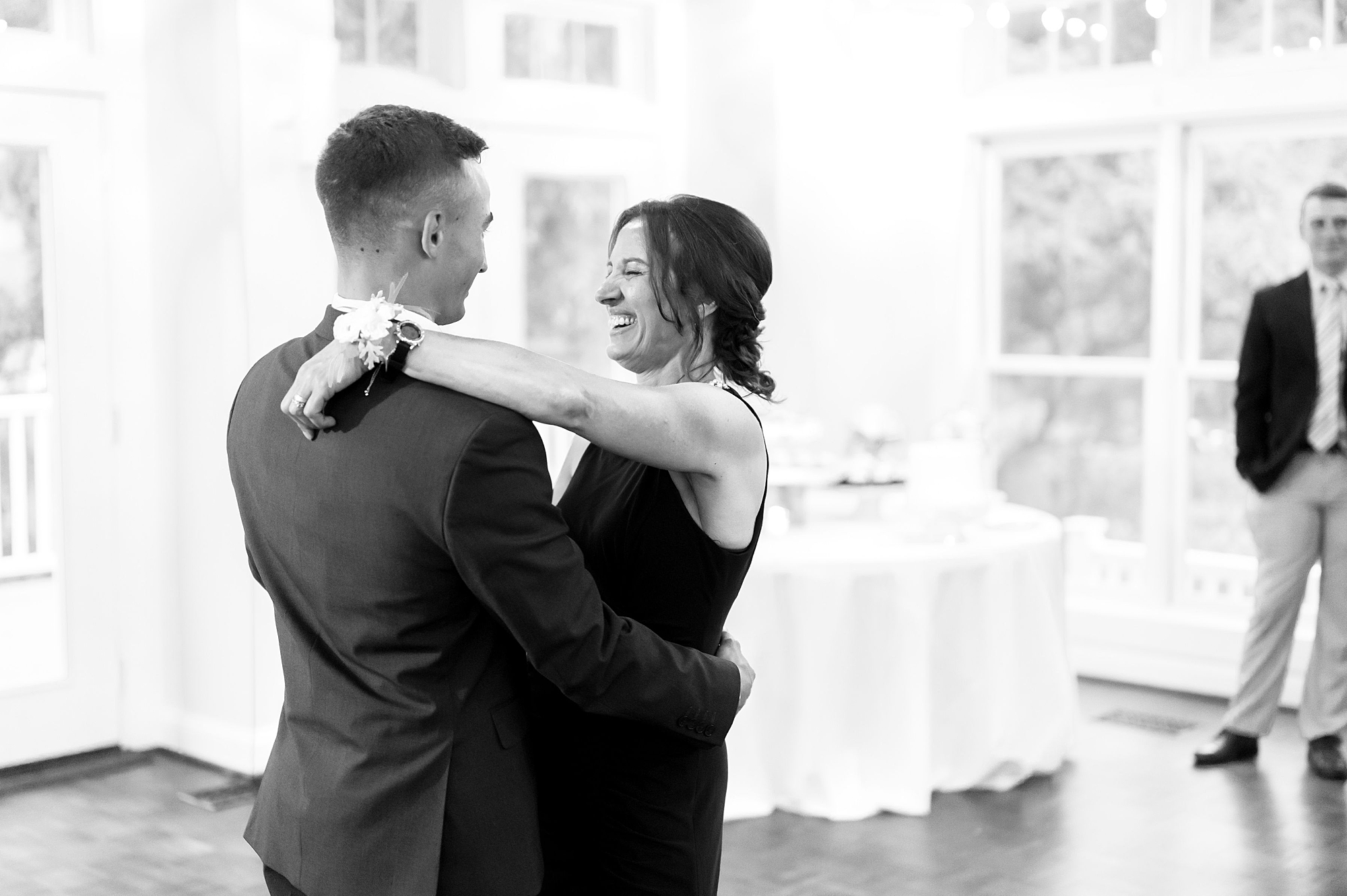 groom dances with mom during wedding reception 