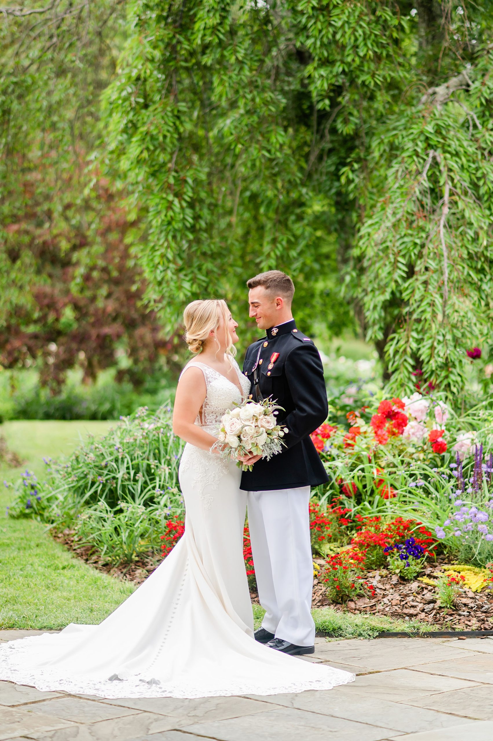 bride and groom stand by flowers at Londontown Gardens
