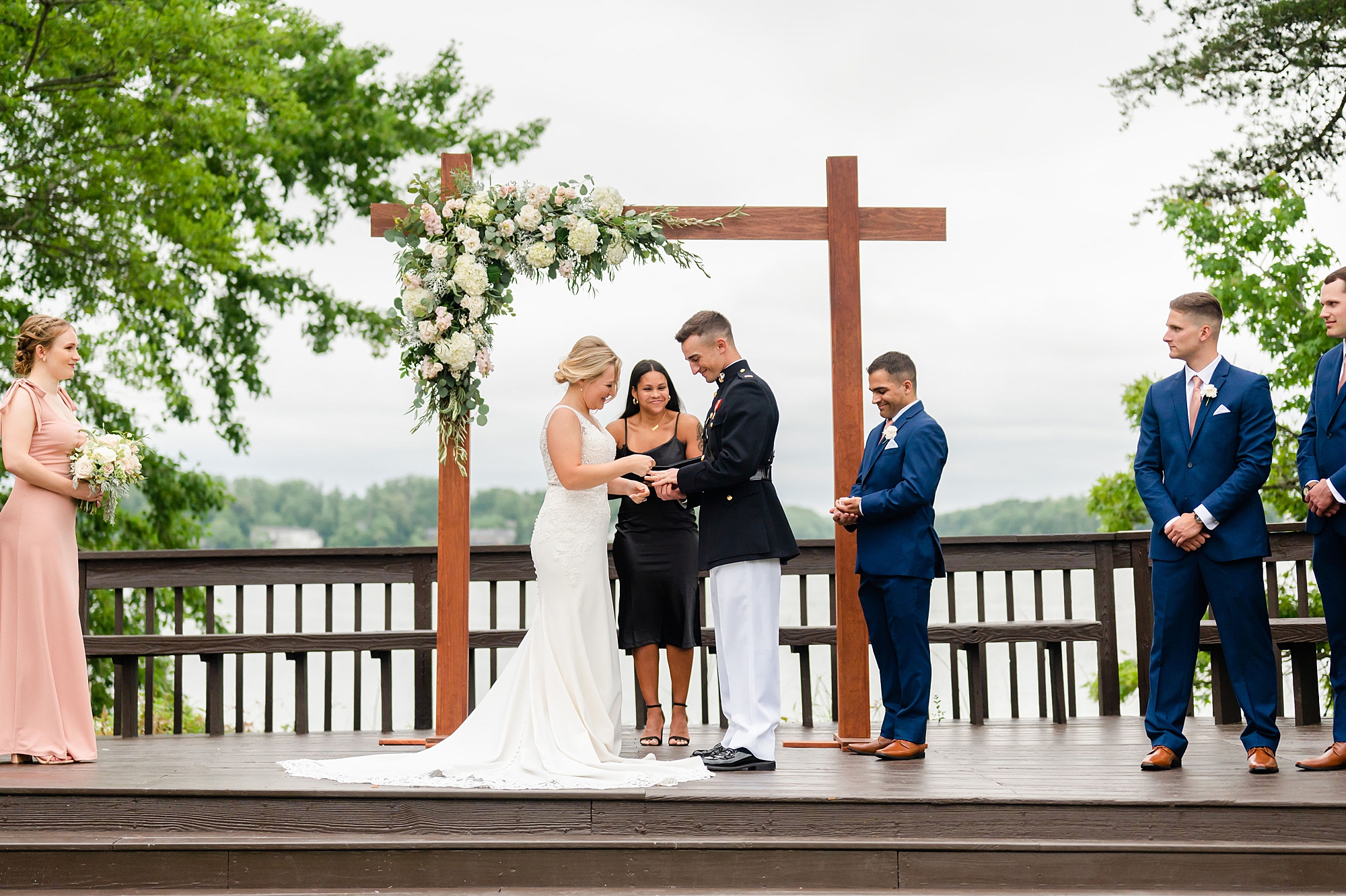 military couple exchanges vows during waterfront wedding ceremony in Edgewater MD