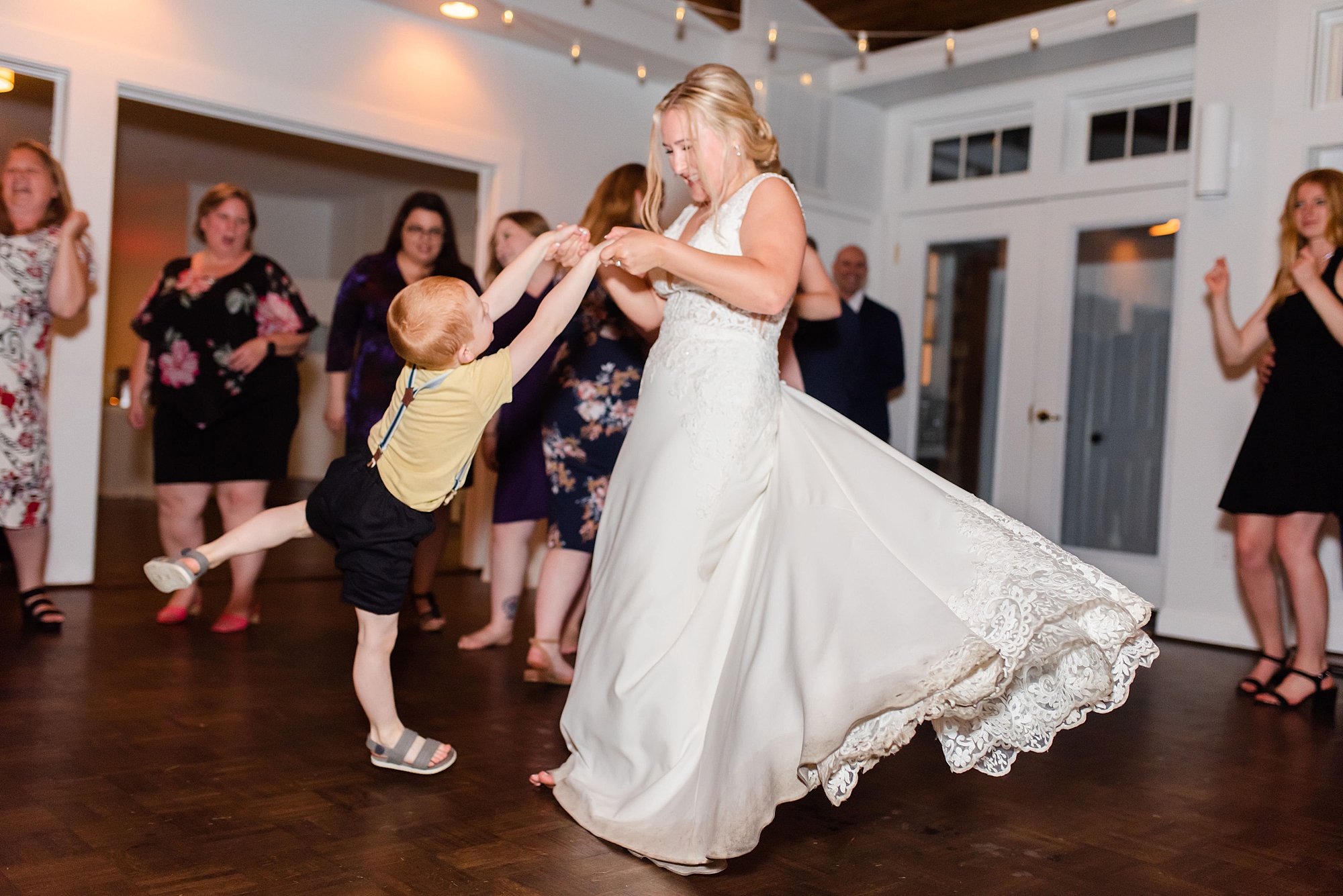 bride dances with young guest during MD wedding reception 