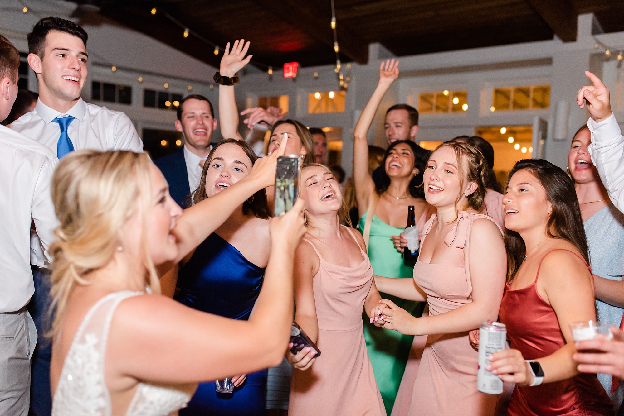 bride dances with friends at wedding reception