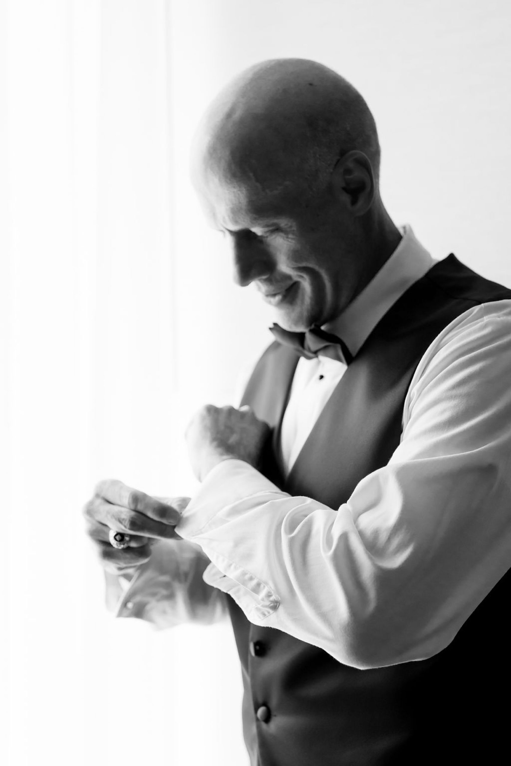 groom adjusts cufflinks in DC hotel