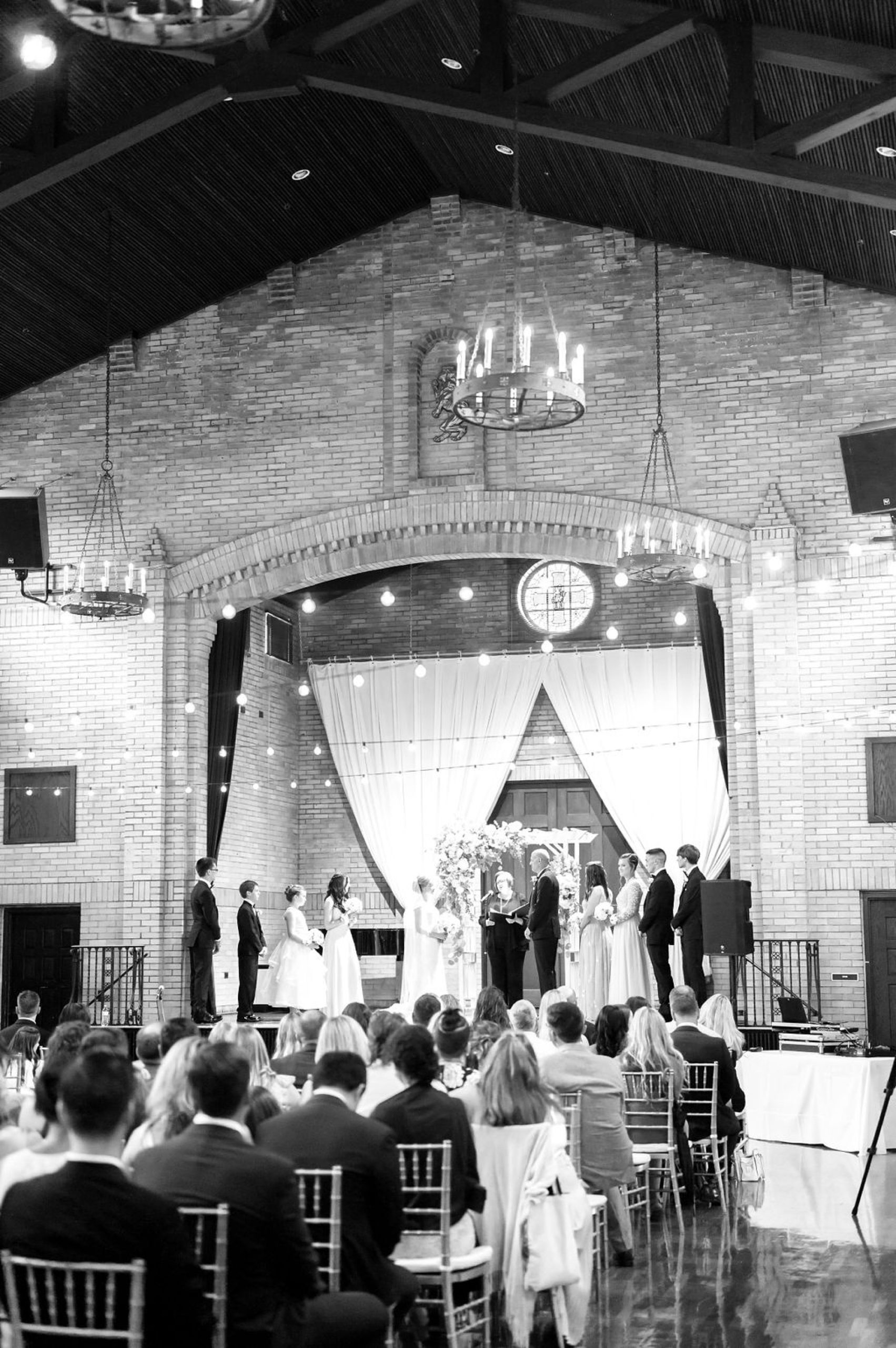 bride and groom's wedding ceremony onstage at Saint Francis Hall