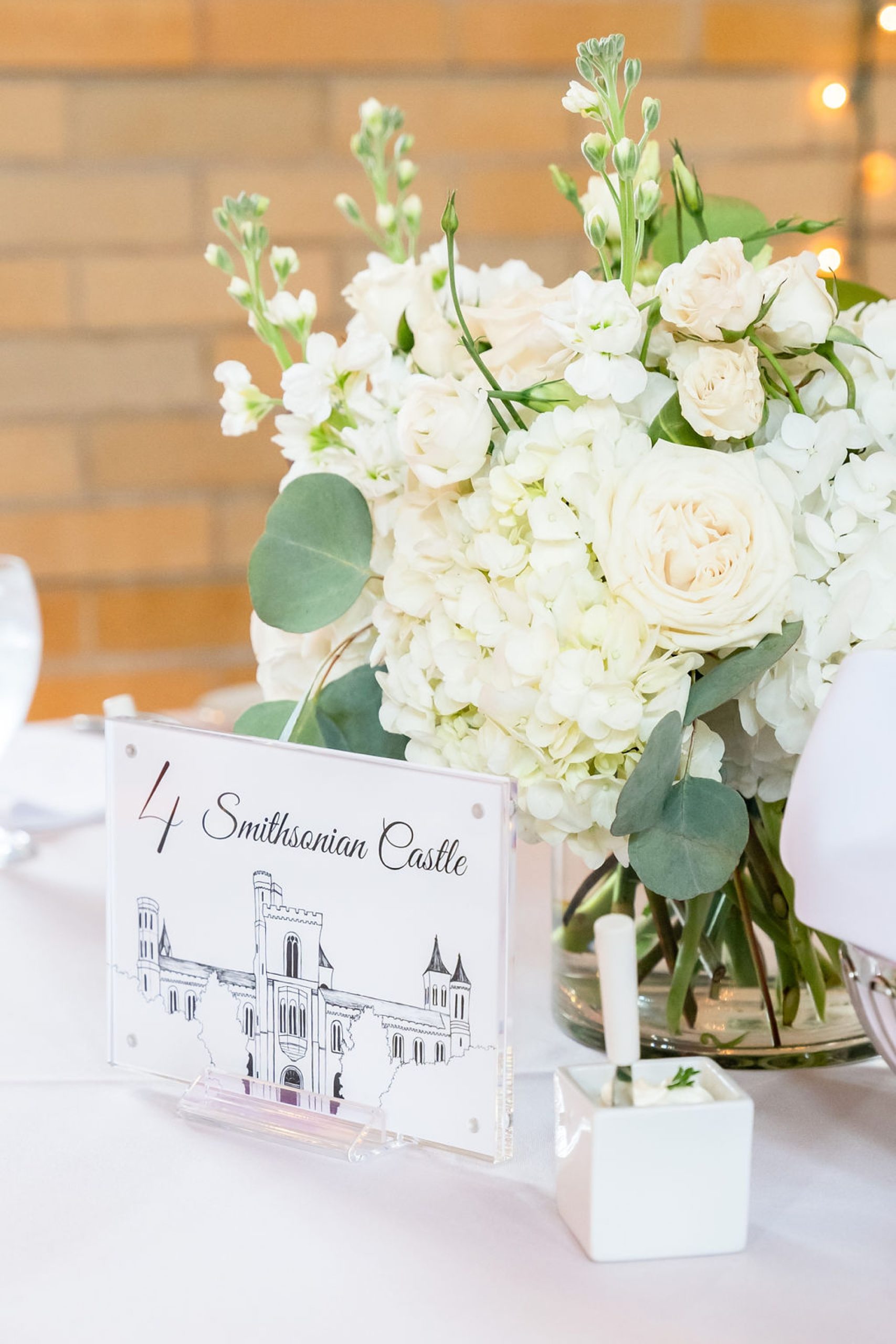 floral centerpieces with DC inspired table numbers at Saint Francis Hall wedding reception