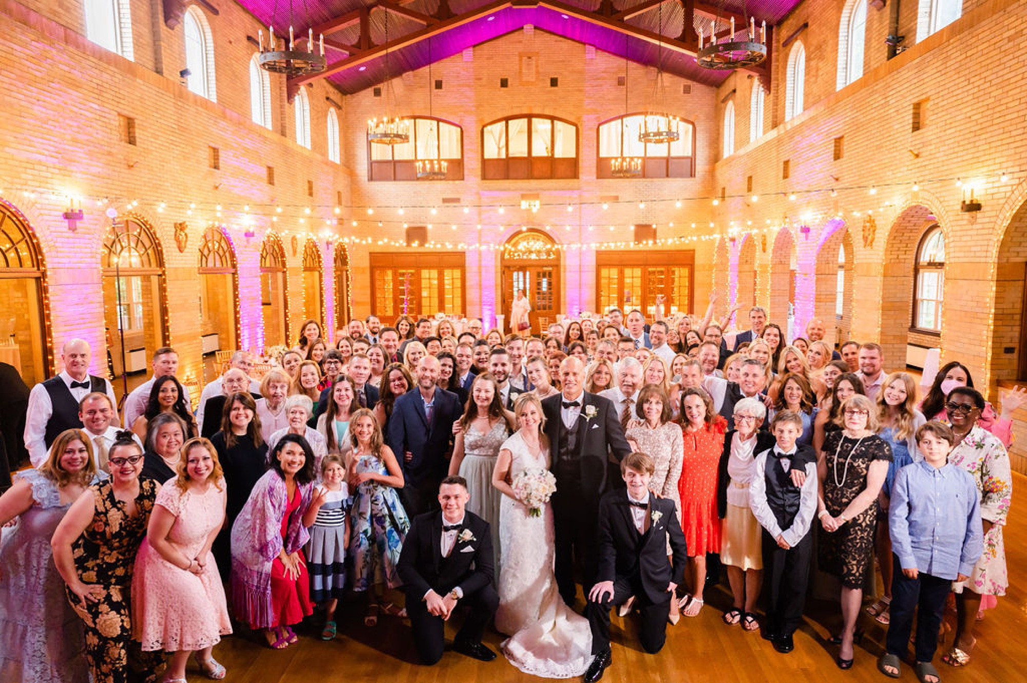 bride and groom pose with guests during DC wedding reception