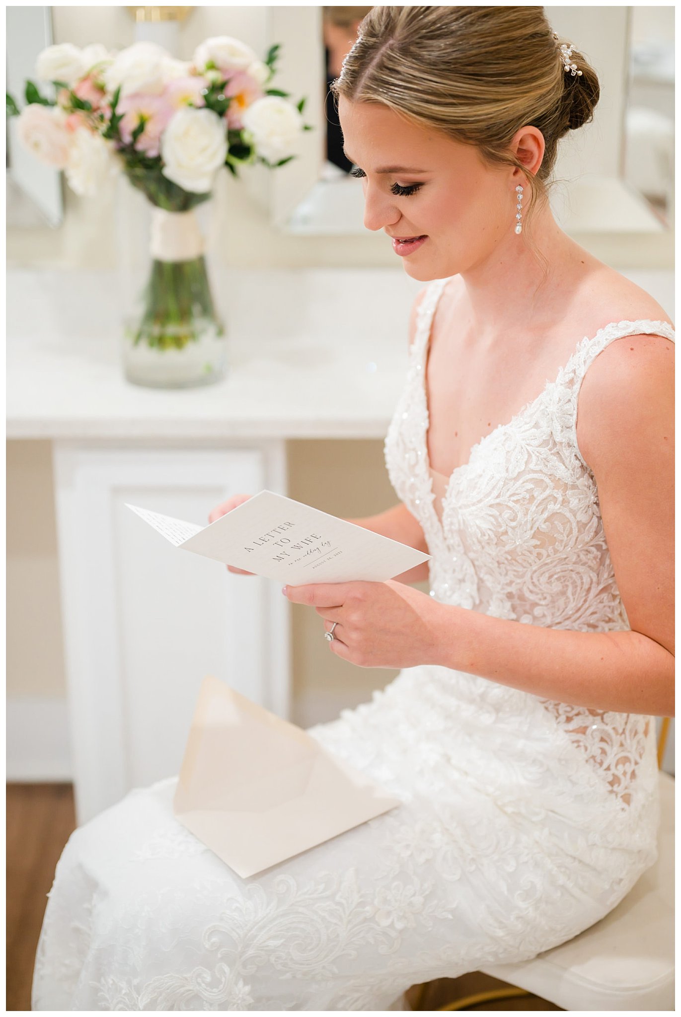 bride reads letter from groom during prep for The Club at Baywood wedding