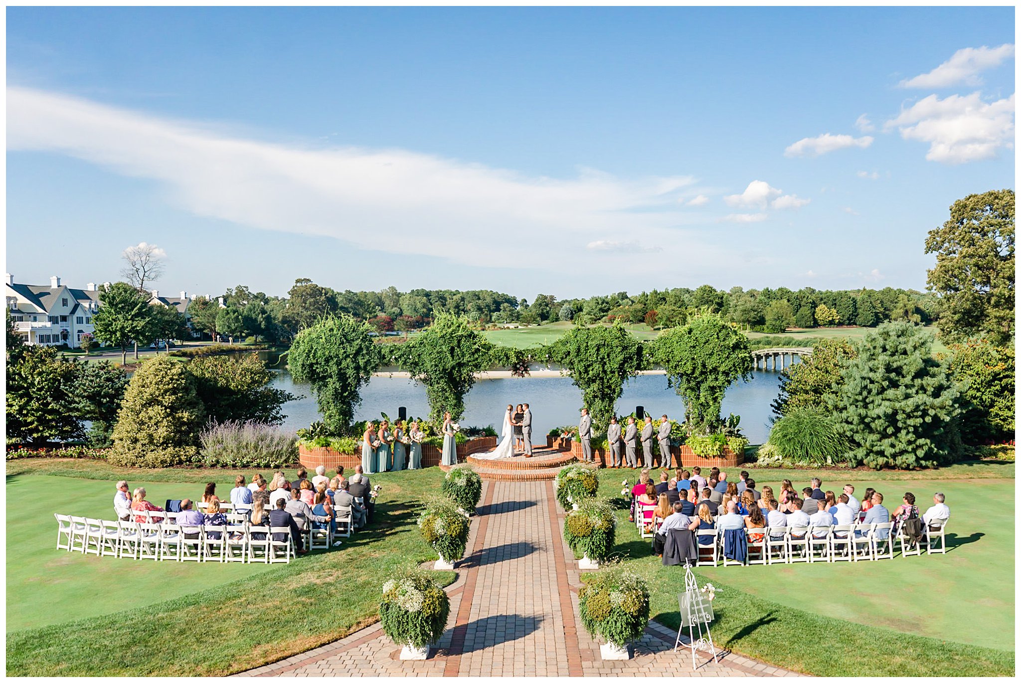 bride and groom exchange vows in gardens of The Club at Baywood