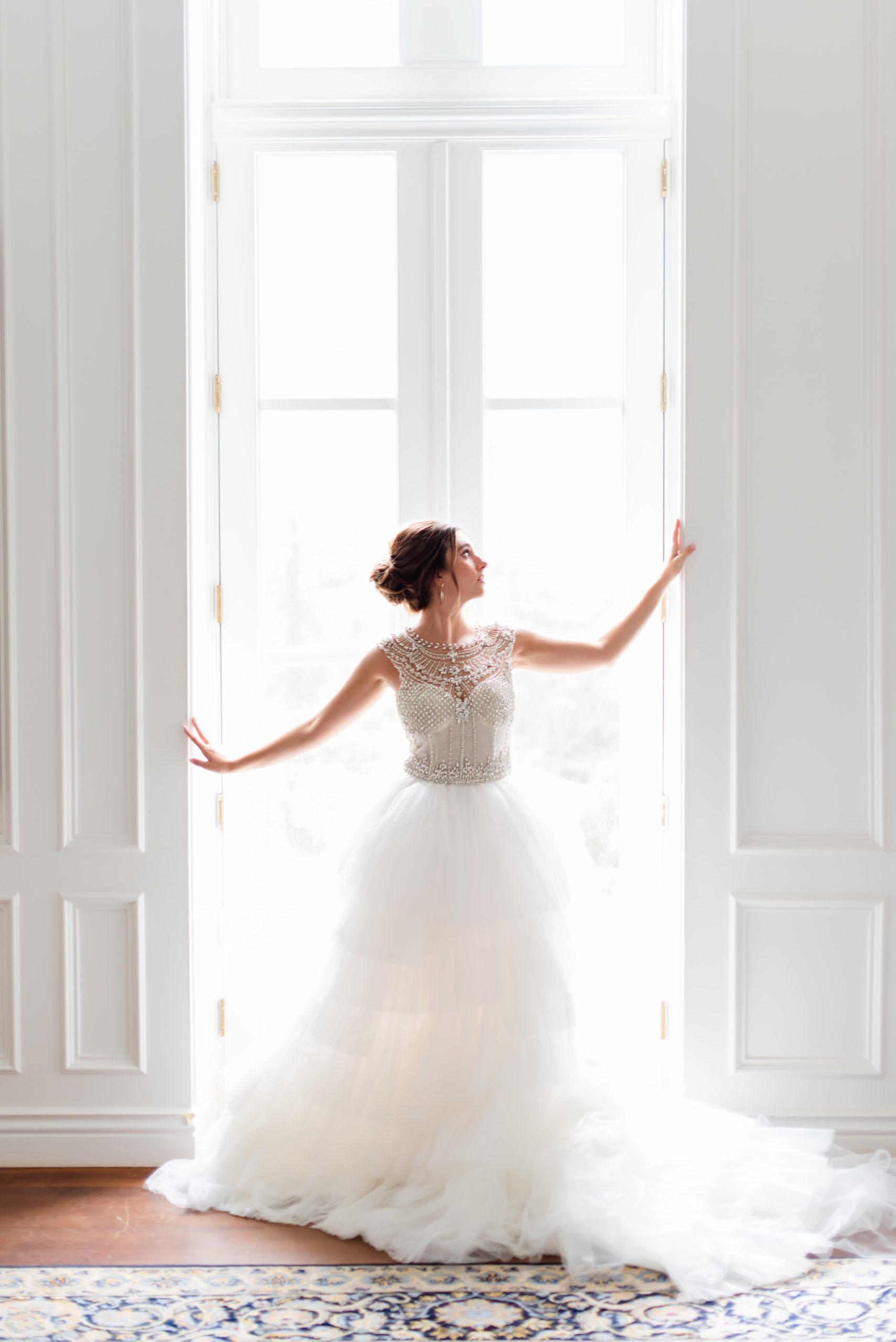 bride poses in window of bridal suite in Washington DC
