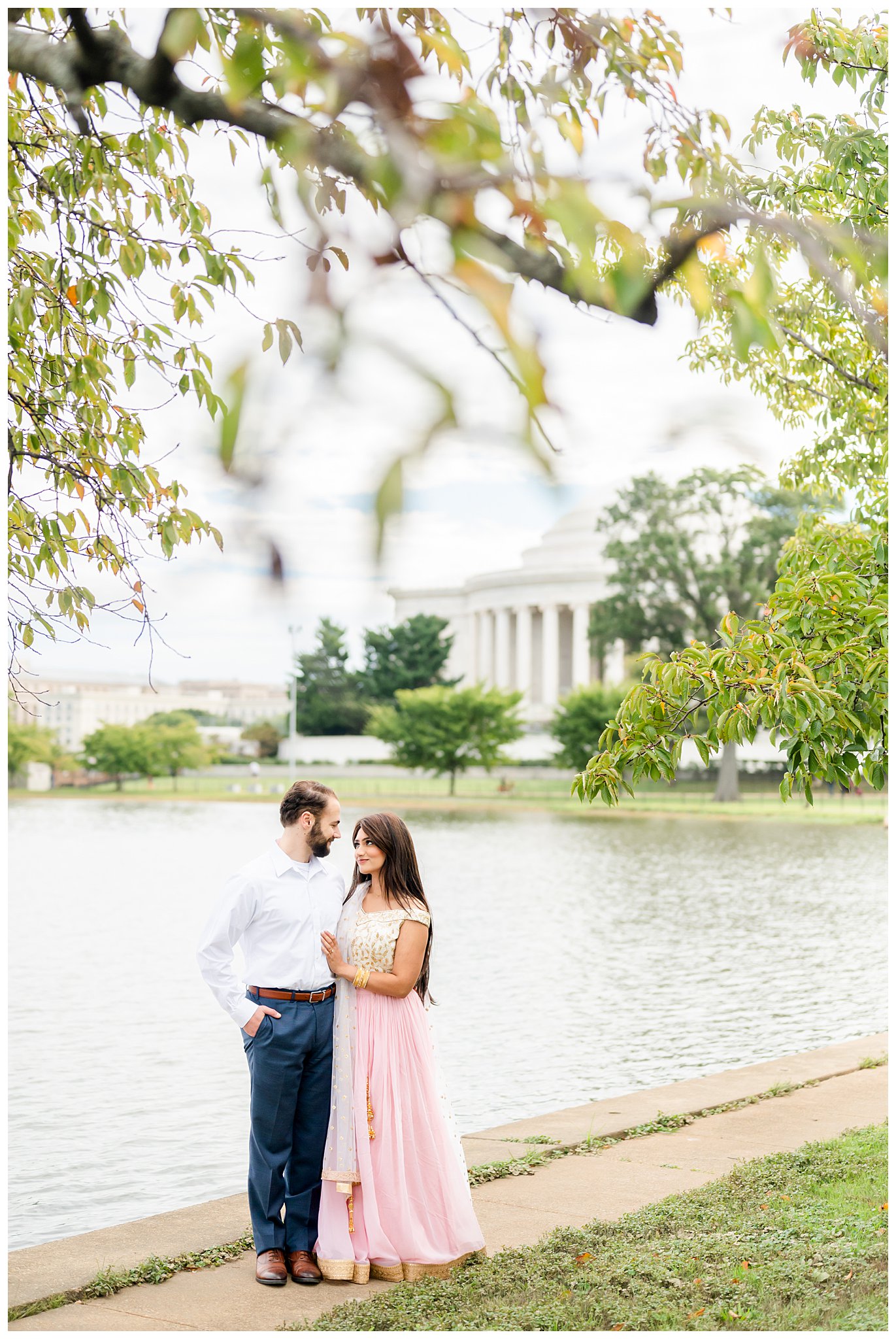 bride and groom hug by Jefferson Memorial