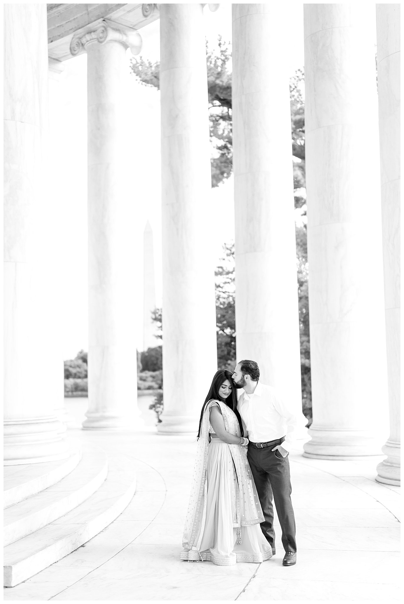 groom kisses bride's cheek during Jefferson Memorial engagement session