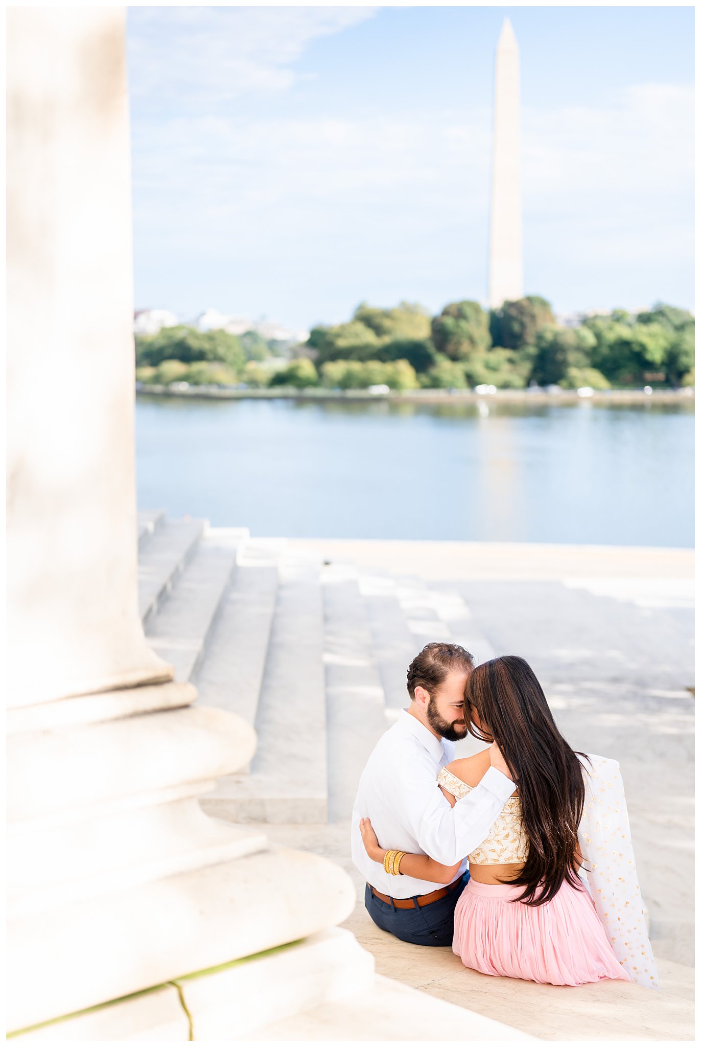 couple sits together on steps of Jefferson Memorial