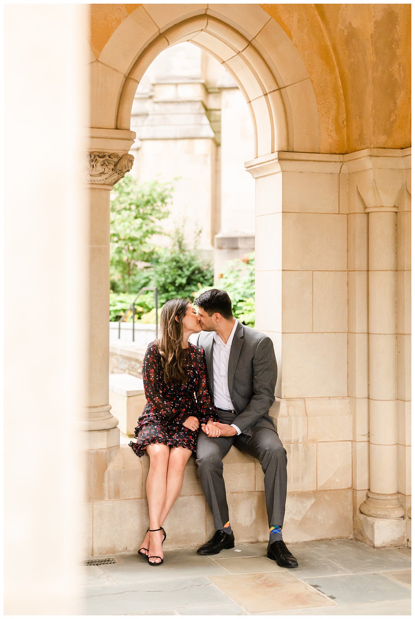 man and woman kiss in alcove at the National Cathedral