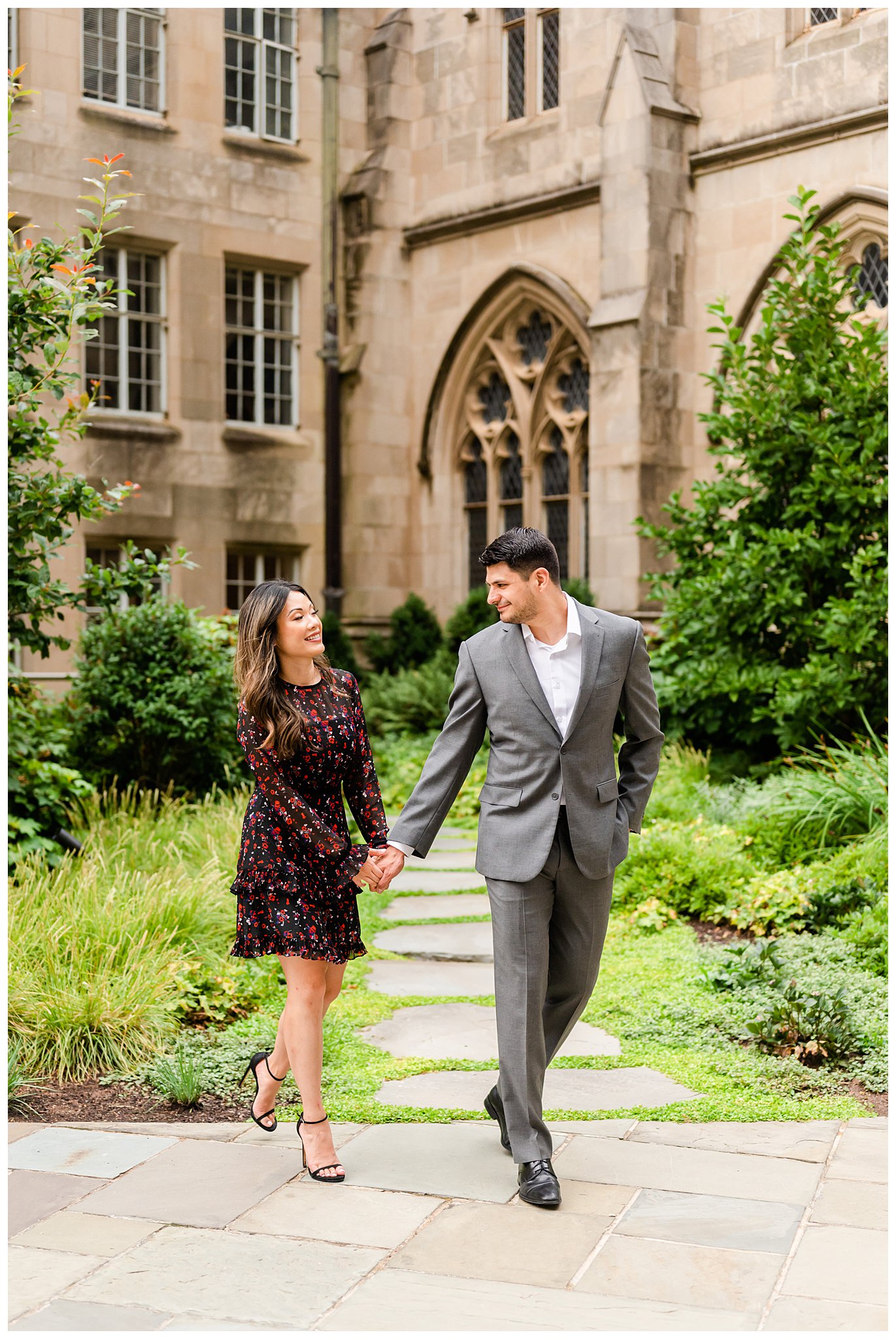 man looks over shoulder laughing at fiancee during National Cathedral engagement session