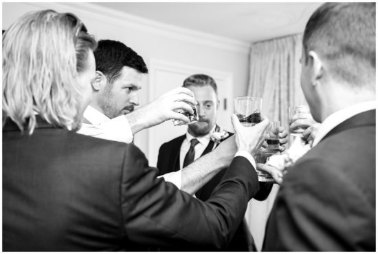 Group of groomsmen toasting
