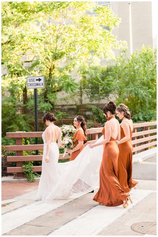 Group of bridesmaids crossing the street