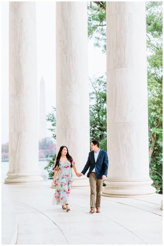 couple walks between columns