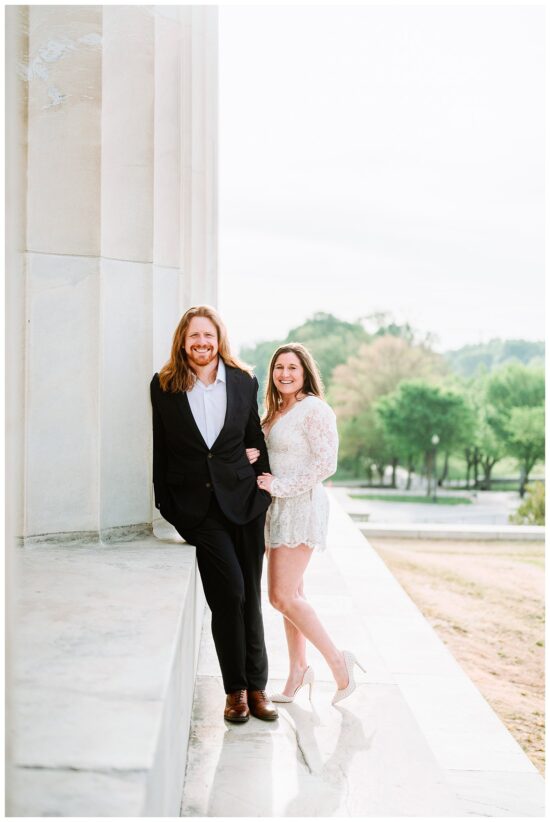 couple leaning on marble column 